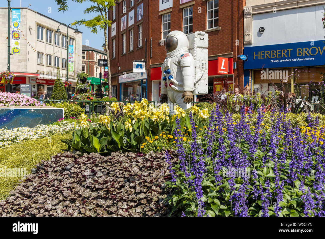 Alien landscape with American astronauts landing on the Moon theme community garden in the middle of town in North West of England. Stock Photo