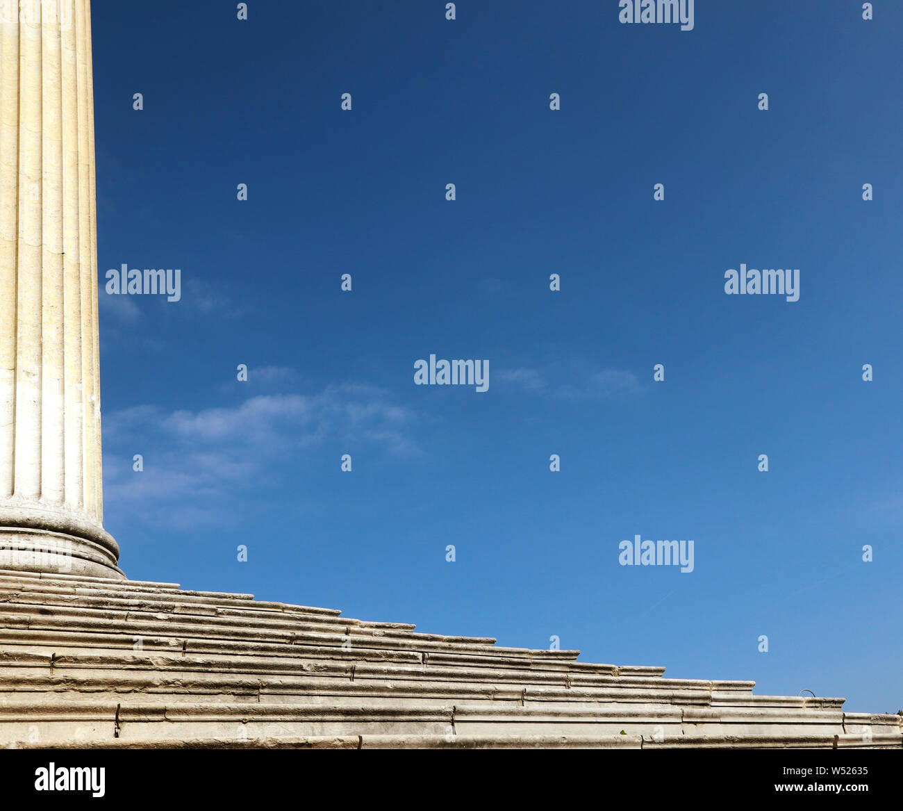 Antique marble column and flight of steps, white symbol of humanity, culture and civilization under a blue sky Stock Photo