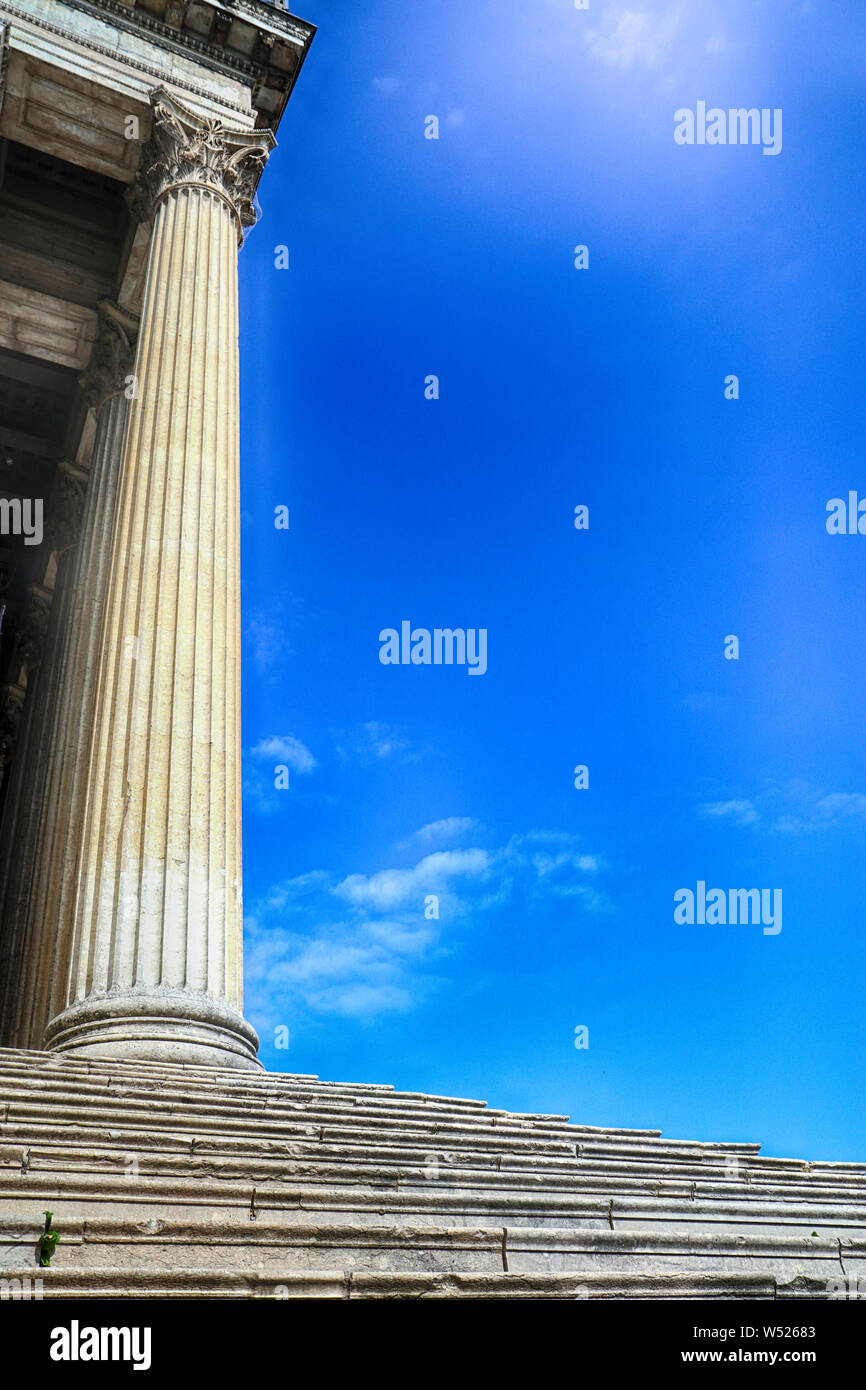 Antique corinthian marble column and flight of steps, white symbol of humanity, culture and civilization under a blue sky Stock Photo