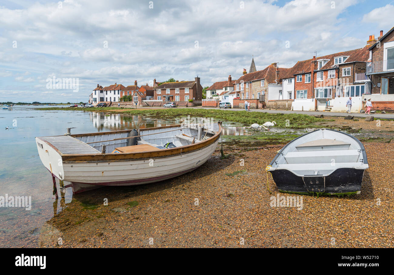 Beached boats in shallow water at low tide in Chichester Harbour, Bosham Village, West Sussex, England, UK. Bosham landscape view. Stock Photo