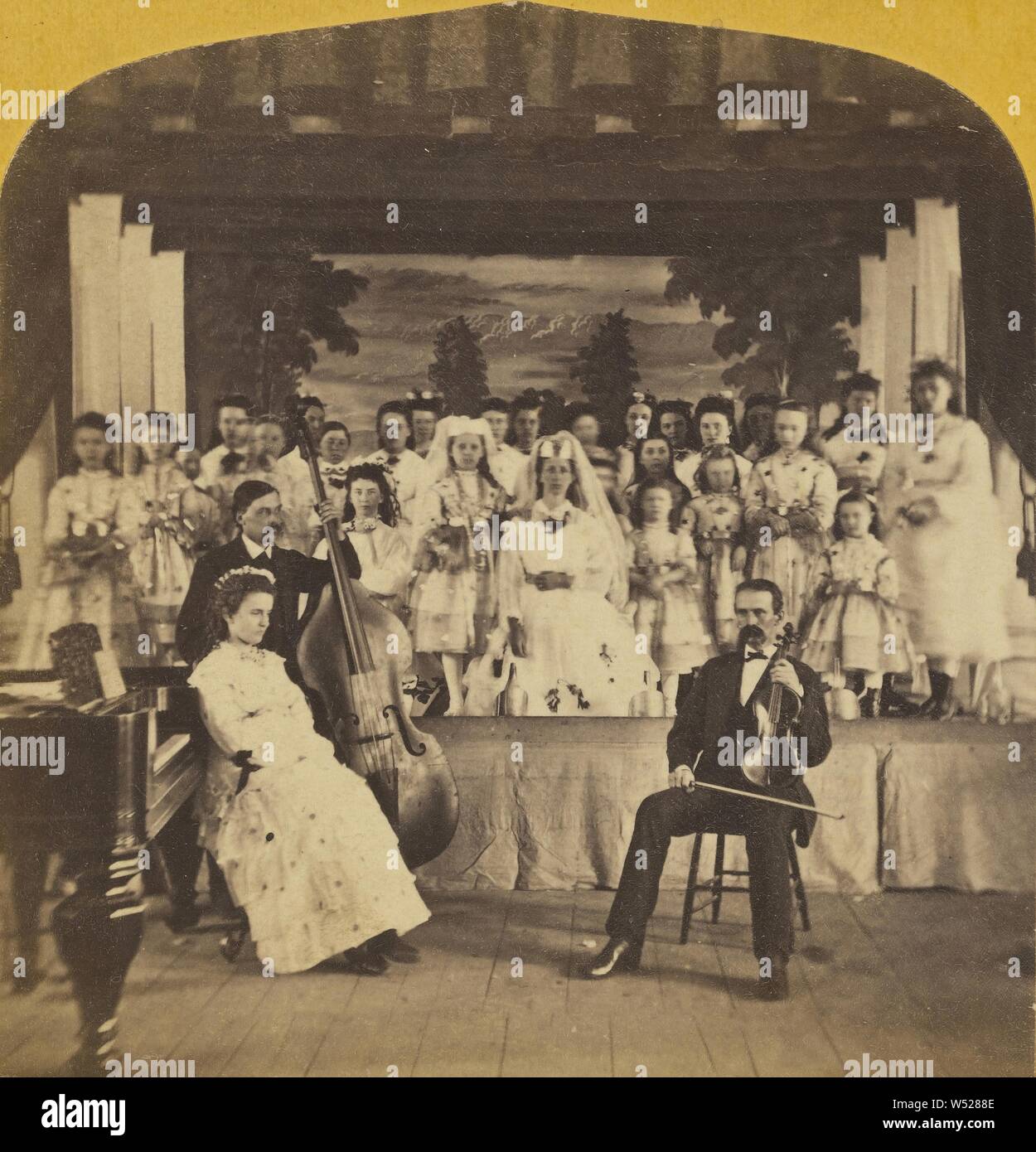 Cast of a play on stage, two male musicians seated in front with well-dressed woman, Charles P. Hibbard (American, 1823 - 1895), 1870s, Albumen silver print Stock Photo