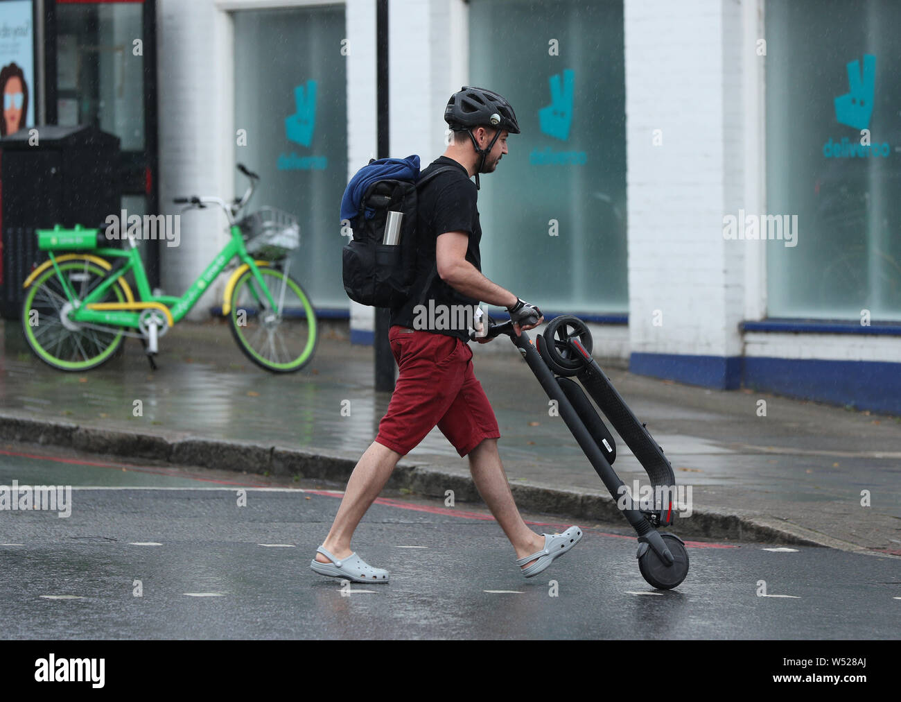 An e scooter rider pushes hires stock photography and images Alamy