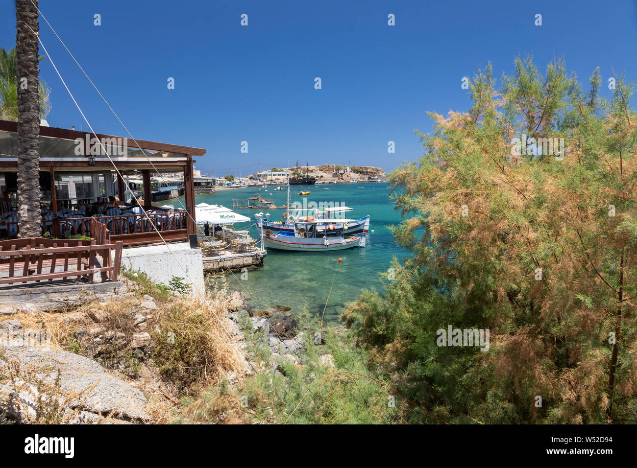 Fishing boats and waterside restaurant Hersonissos, Crete, Greece
