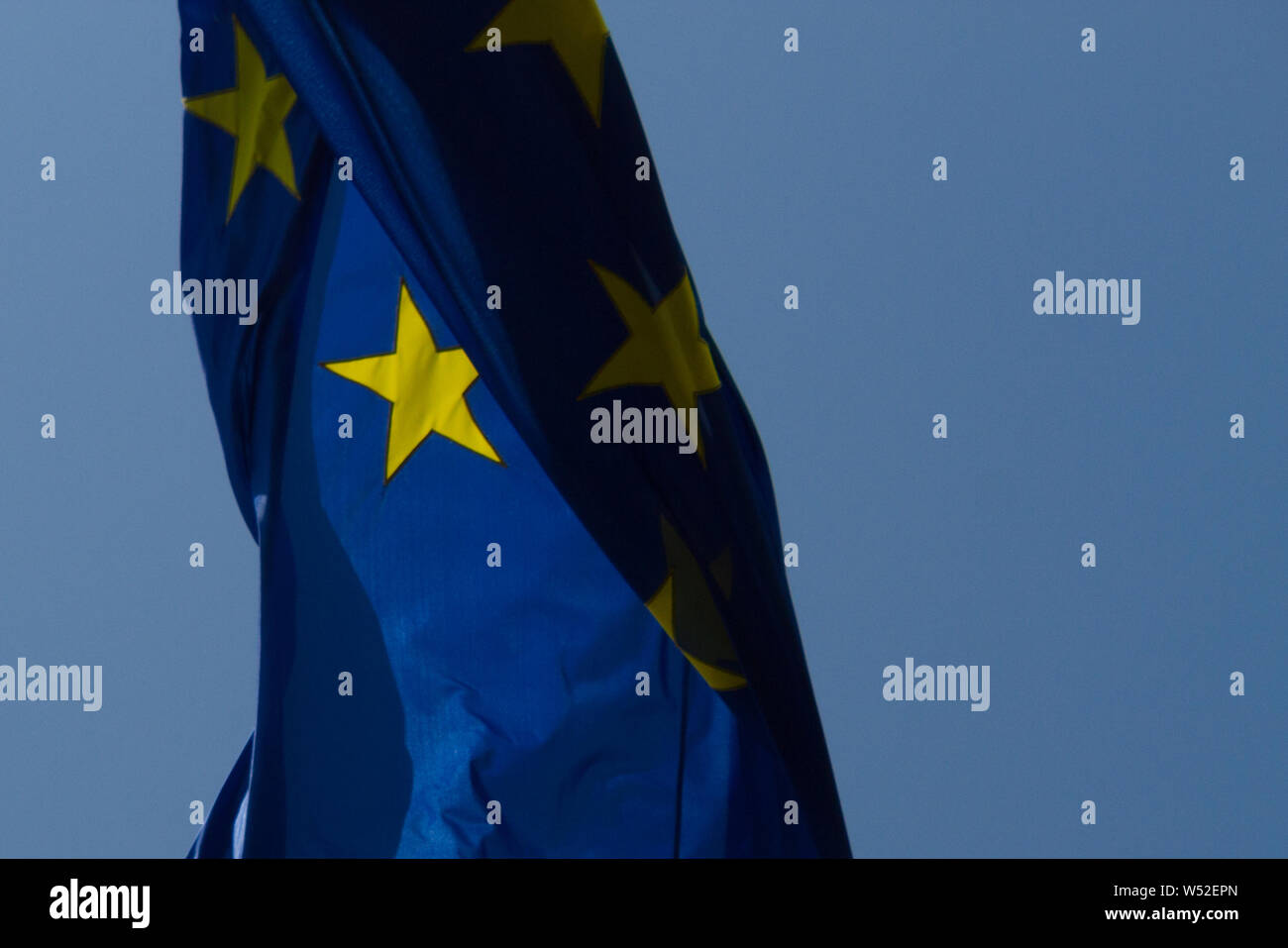 European Union flag on blue sky background Stock Photo - Alamy