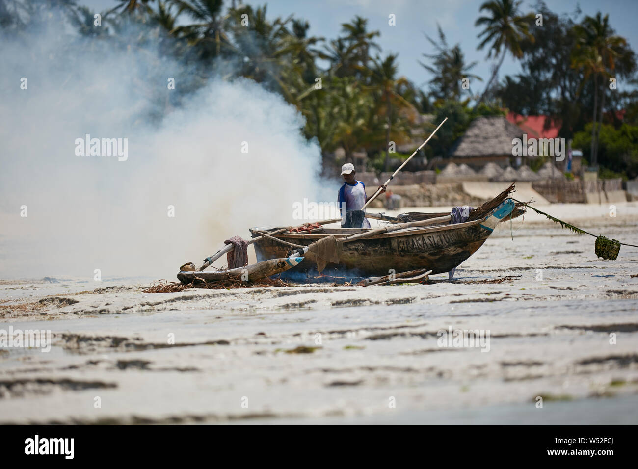 African fisherman are burning his boat Stock Photo