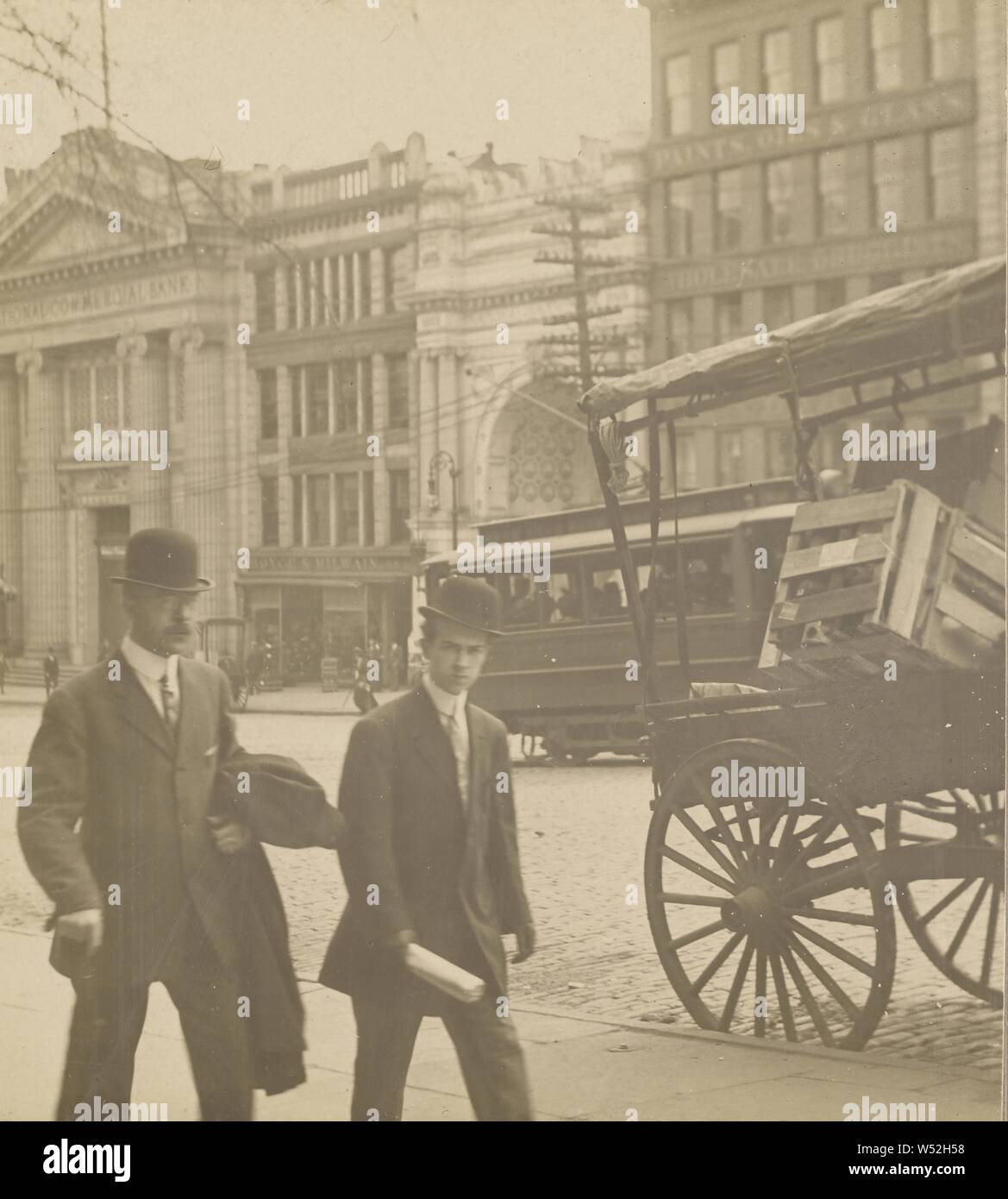 Albany, N.Y. street scene, two men in derbies walking past a vegetable cart, Julius M. Wendt (American, active 1900s - 1910s), 1900s, Gelatin silver print Stock Photo