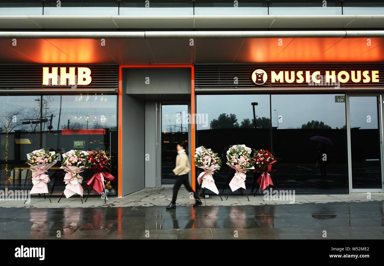 Pedestrians walk past the HHB Music House, a pub frequently visited by Jack Ma or Ma Yun, Chairman of Alibaba Group, and other stars and celebrities, Stock Photo