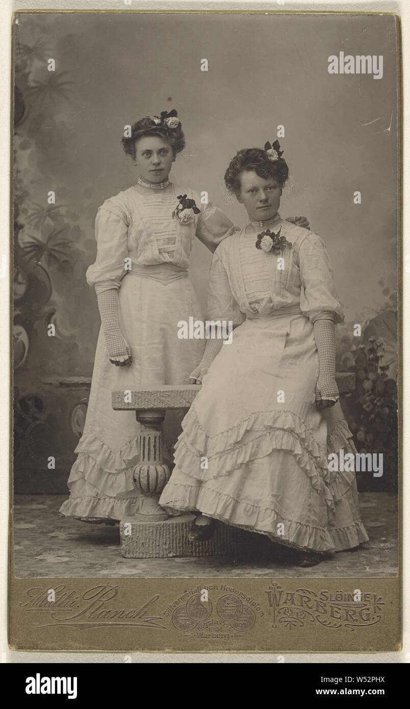 Two unidentified women wearing identical white dresses, both with flowers in hair and on dresses, Mathilda Ranch (Swedish, 1860 - 1938), 1908, Platinum print Stock Photo