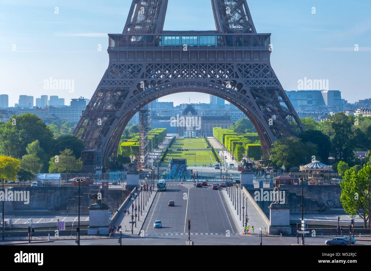 France, Paris. Eiffel Tower and Champ de Mars. Few tourists and cars in the summer sunny morning Stock Photo