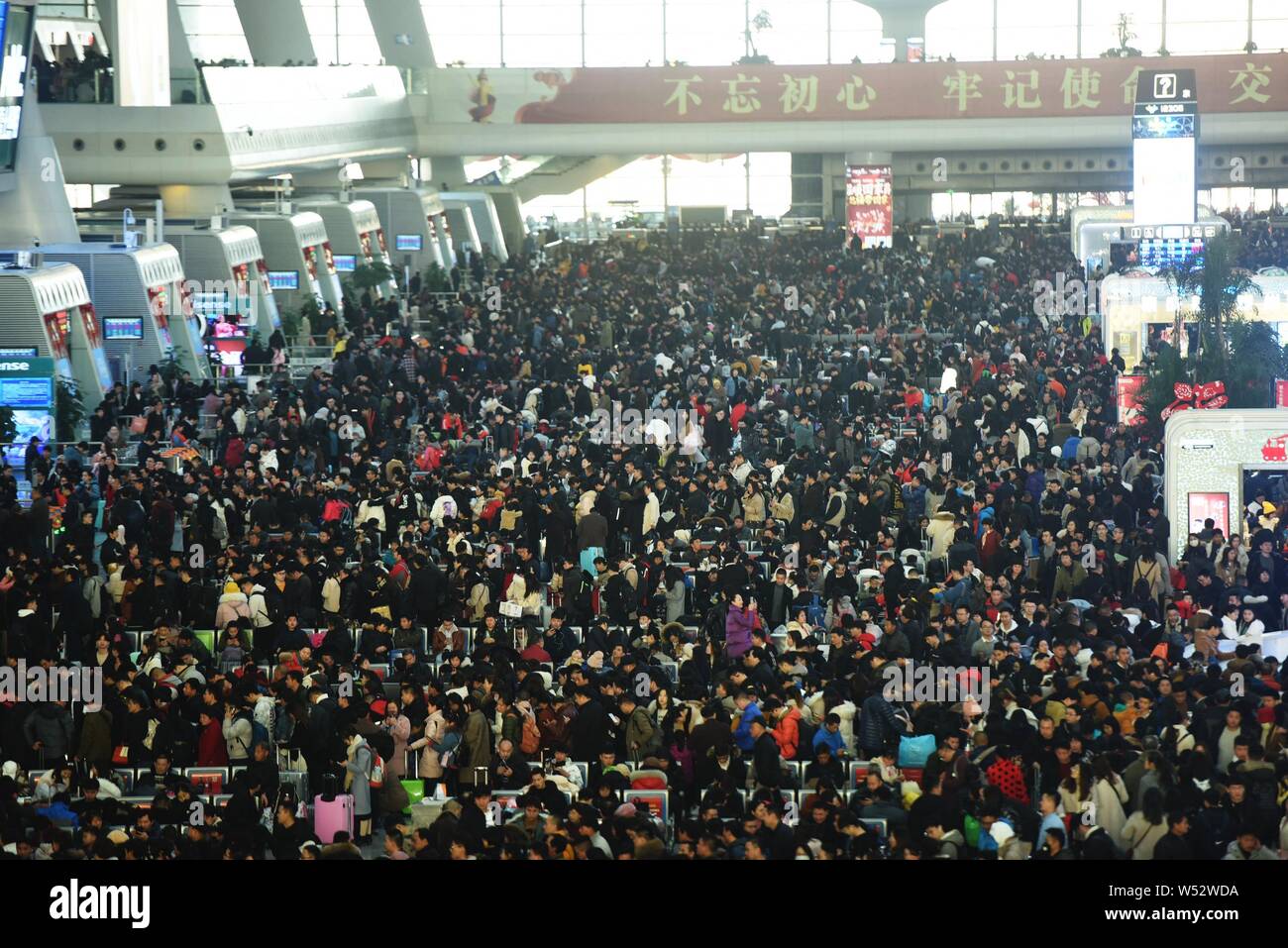 Passengers wait for their trains to go back home for the Chinese Lunar