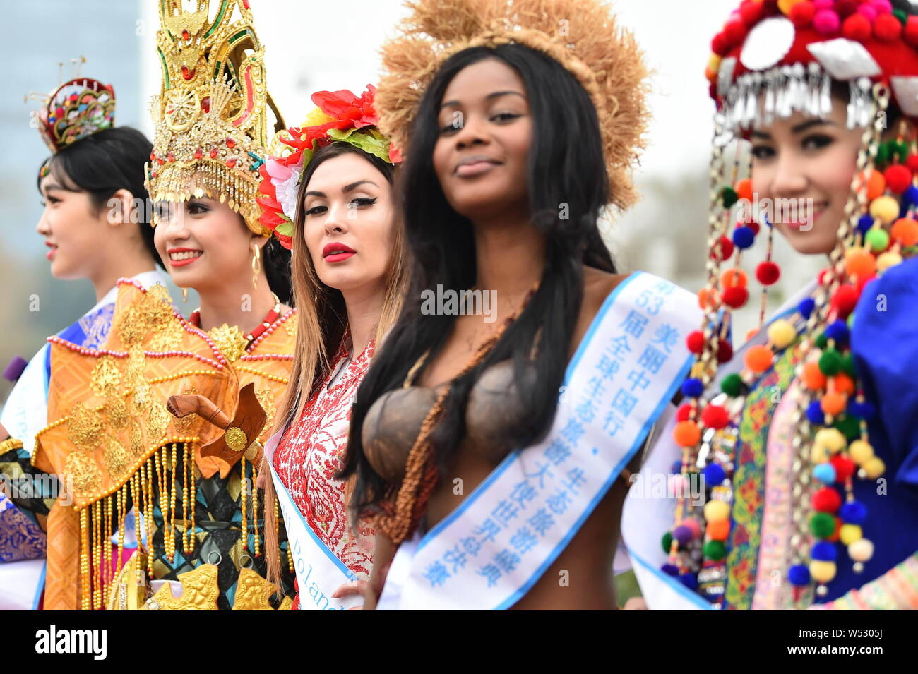 Contestants dressed in traditional costumes take part in an outdoor photo session for the 53th Miss All Nationsl Pageant in Nanjing city, east China's Stock Photo