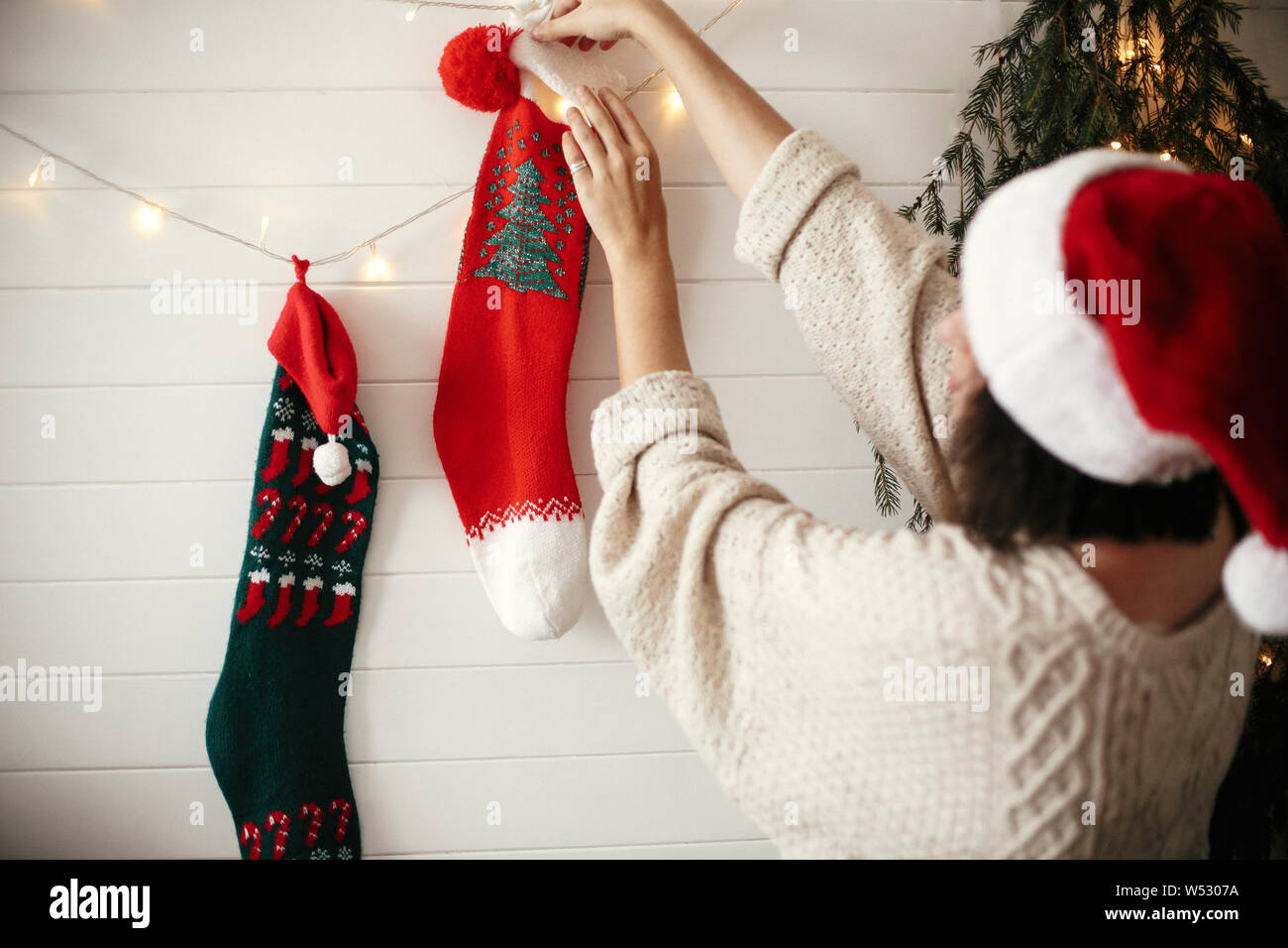 Stylish girl in cozy sweater and santa 