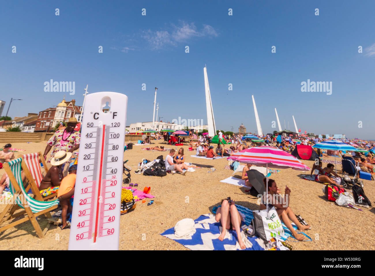 FAKE IMAGE. Jubilee Beach, Southend on Sea, Essex, UK on a day when temperatures reached record levels. Thermometer altered to read 50 degrees Celsius Stock Photo