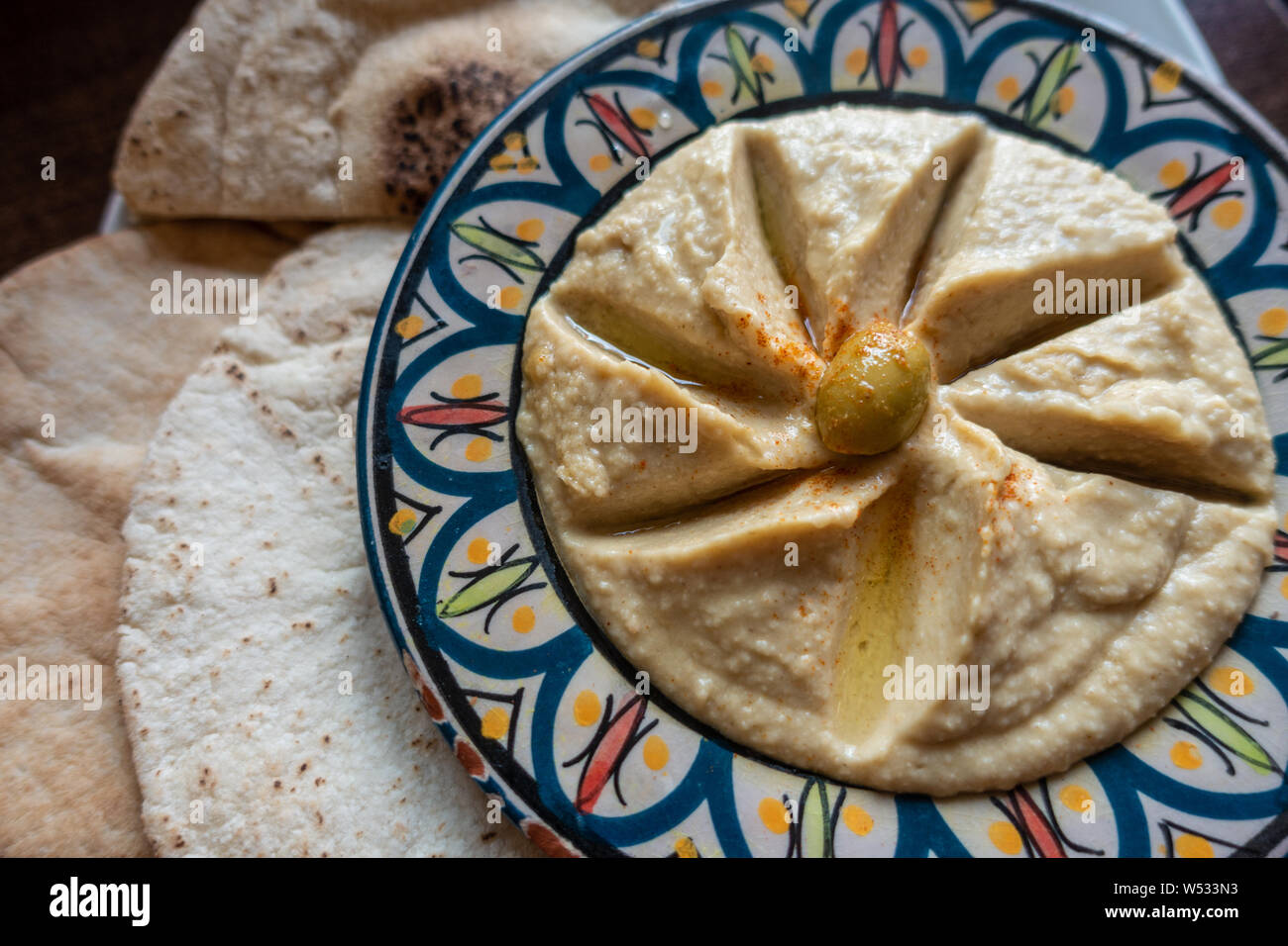 A Plate of hummus with pita bread served as an appetiser in a Moroccan restaurant. Stock Photo