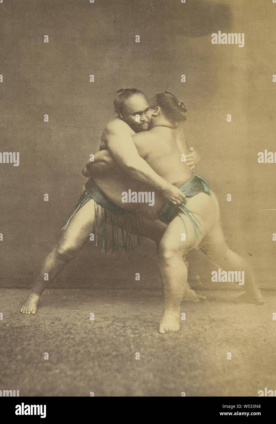 Two Japanese Sumo Wrestlers in Grappling Pose, Felice Beato (English, born Italy, 1832 - 1909), or Baron Raimund von Stillfried (Austrian, 1839 - 1911), Japan, 1868–1880, Hand-colored albumen silver print, 13.8 × 9.5 cm (5 7/16 × 3 3/4 in Stock Photo