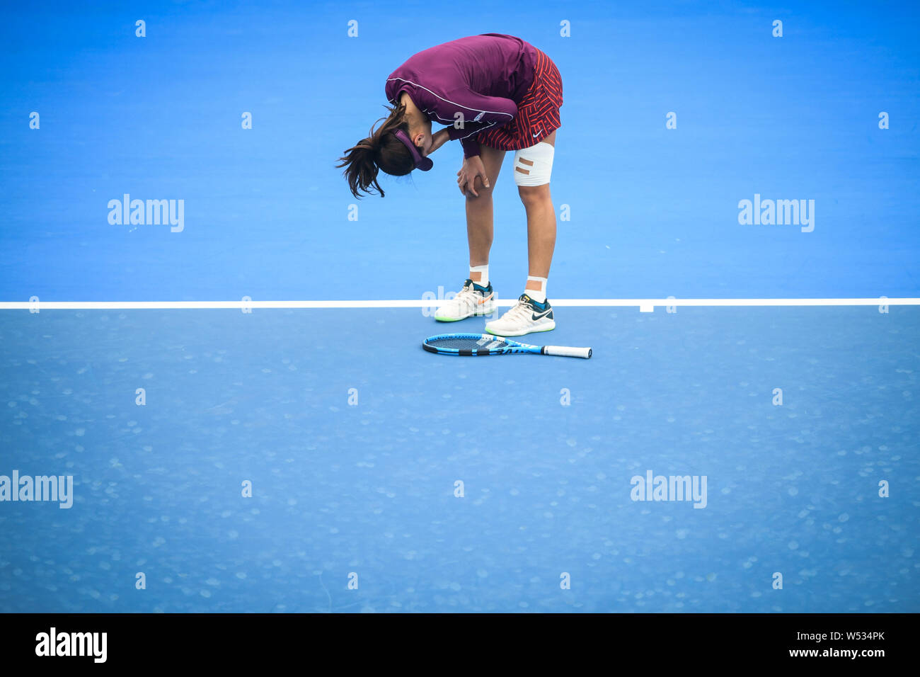 Wang Xinyu of China falls down while competing against Maria Sharapova of Russia in their second round match of the women's singles during the 2019 WT Stock Photo