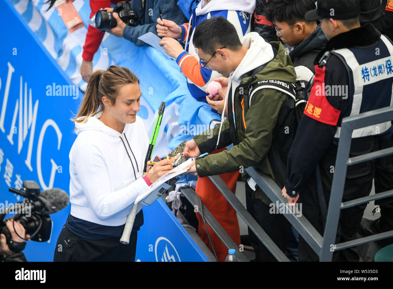 Aryna Sabalenka, left, of Belarus signs autographs for fans ahead of the 2019 WTA Shenzhen Open tennis tournament in Shenzhen city, south China's Guan Stock Photo