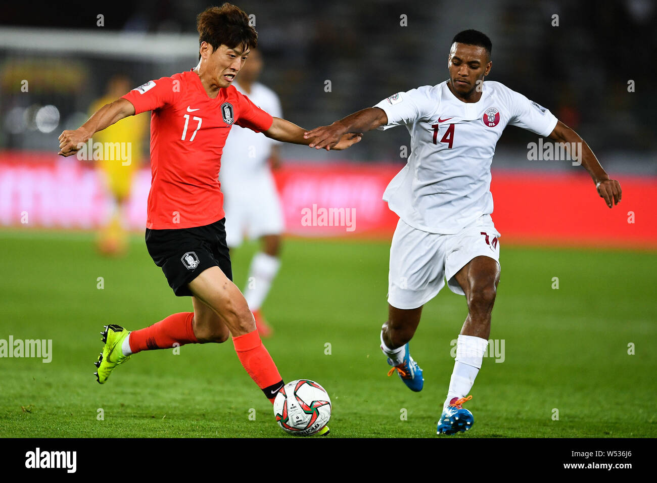 Lee Chung-yong, left, of South Korea national football team passes the ball against a player of Qatar national football team in their quarter-final ma Stock Photo