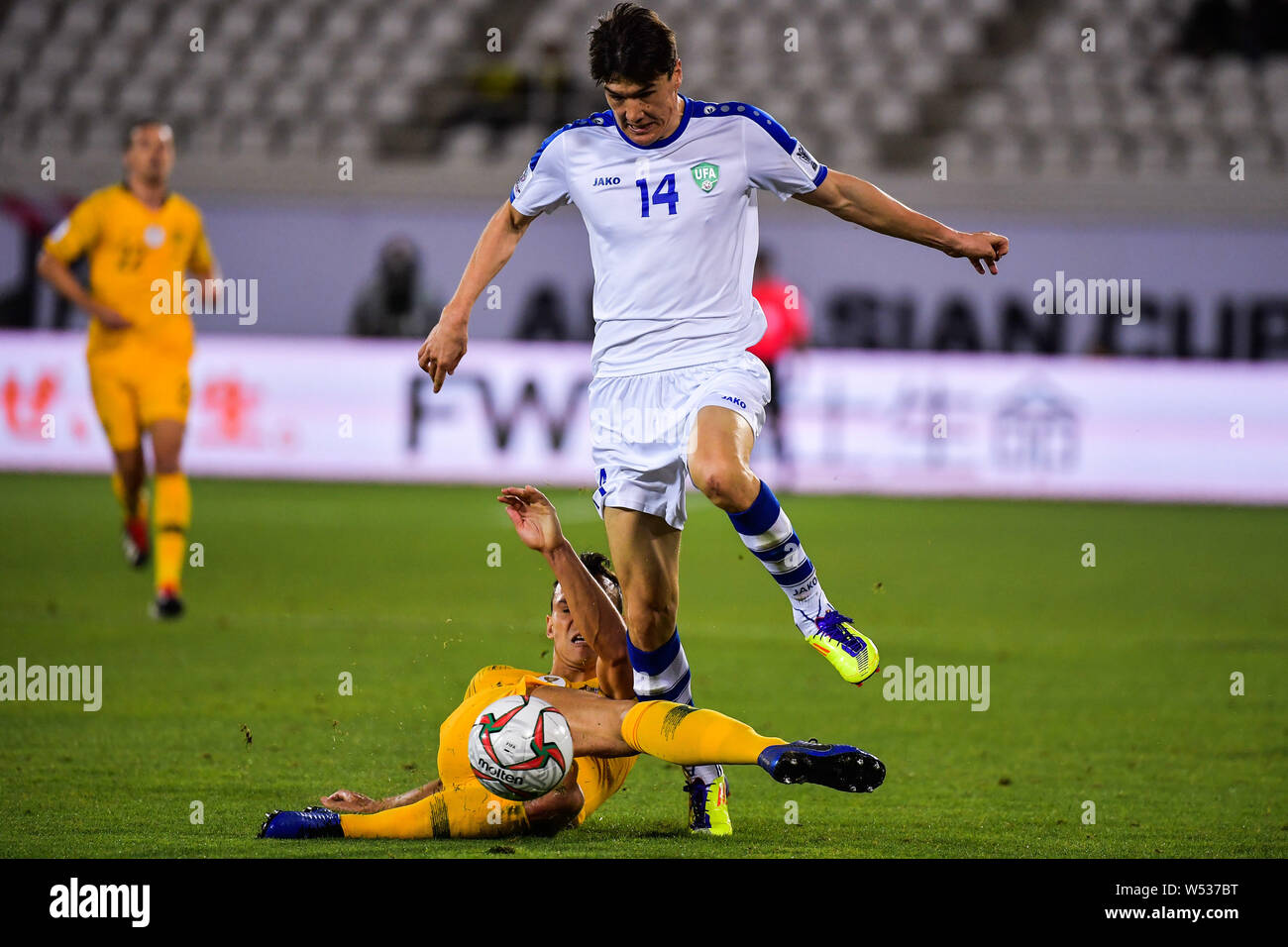 Eldor Shomurodov, right, of Uzbekistan national football team passes