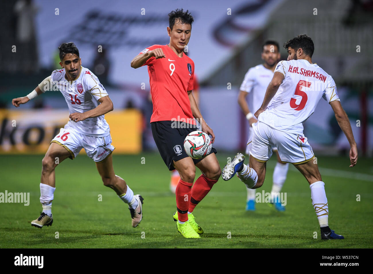 Ji Dong-won of South Korea, center, dribbles against Bahrain in the round of 16 match between South Korea and Bahrain during the 2019 AFC Asian Cup in Stock Photo