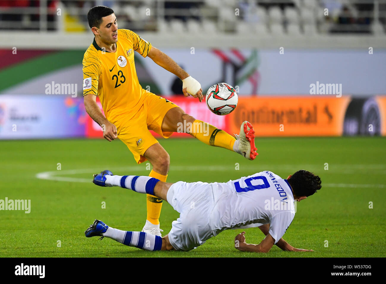 Tom Rogic, left, of Australia national soccer team passes the ball against Odil Ahmedov of