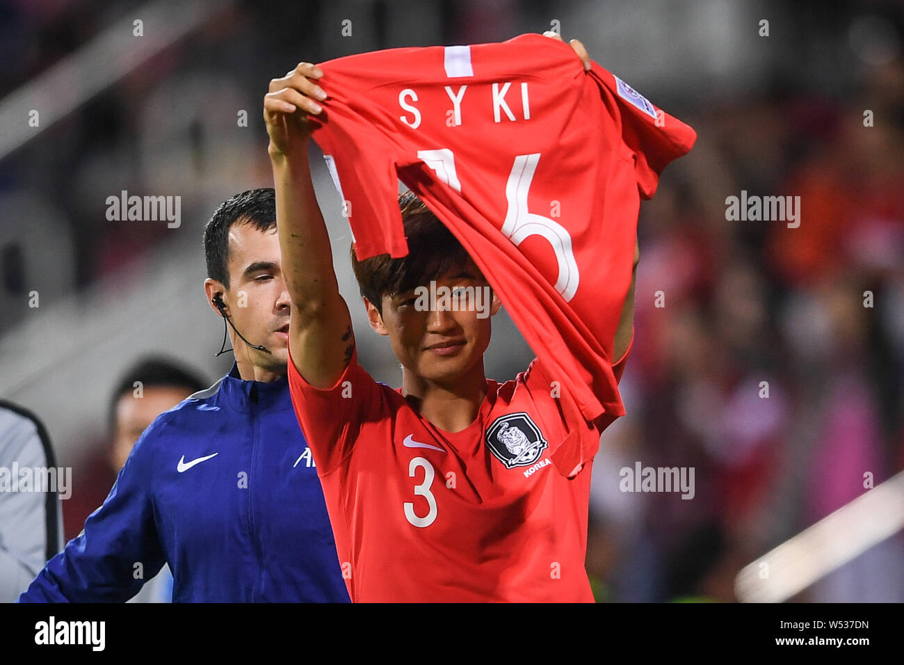 Kim Jin-su of South Korea holds up the 16 shirt of injured Ki Sung-yueng after soring a goal against Bahrain in the round of 16 match between South Ko Stock Photo