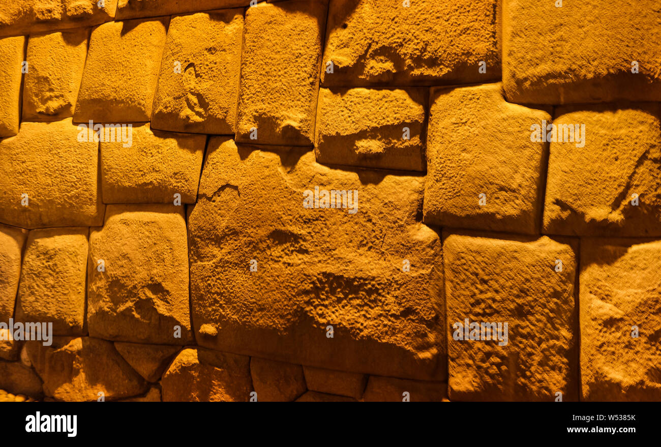 View to Twelve-angled stone aka Hatun Rumiyoc as a part of a wall of the palace of the Archbishop of Cuzco in Peru Stock Photo