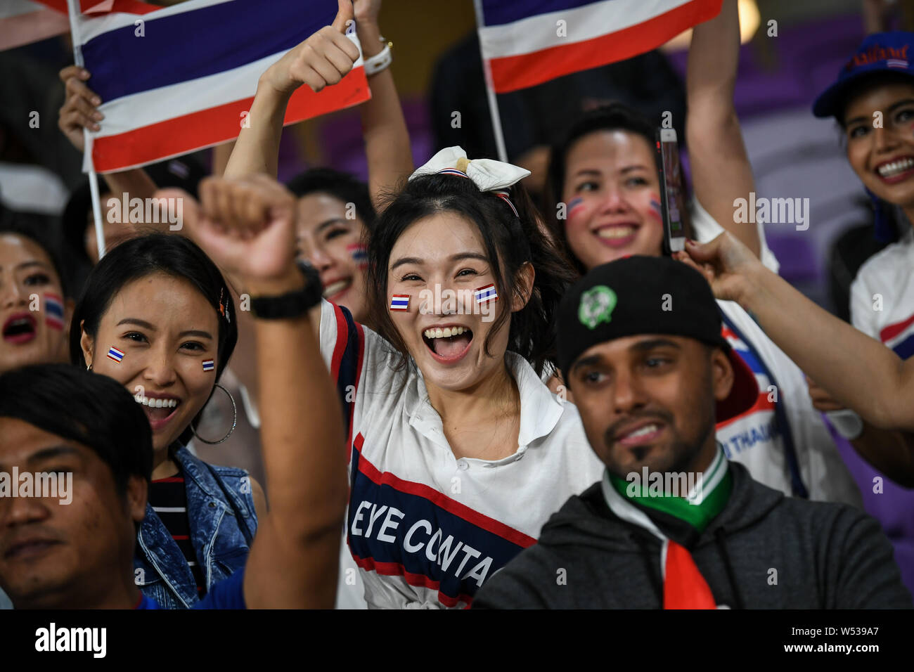 Thai football fans wave their national flags to show support for Thailand  national football team in the AFC Asian Cup group F match against United  Ara Stock Photo - Alamy