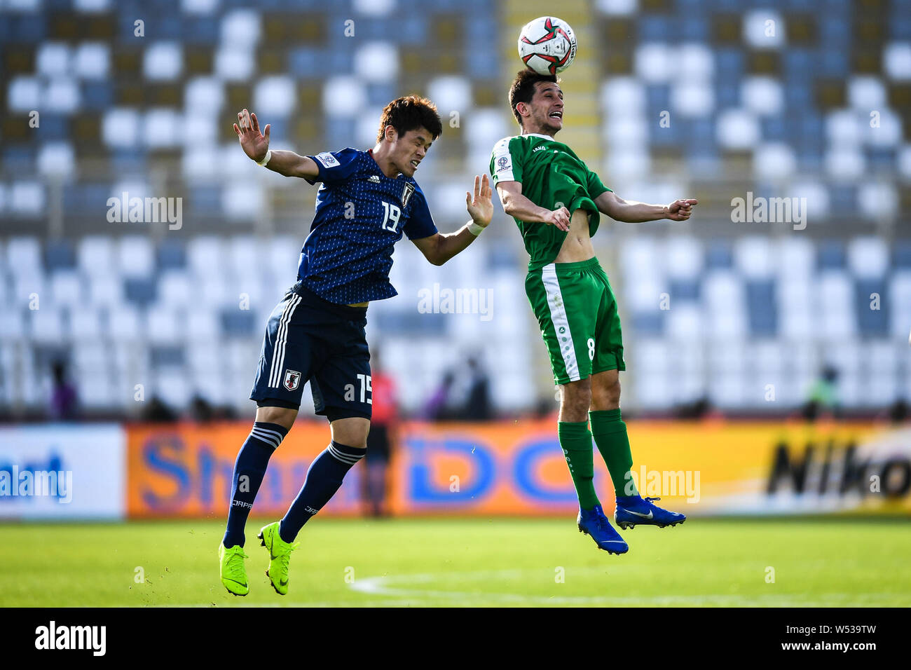 Ruslan Mingazow, right, of Turkmenistan national football team heads the ball against Hiroki Sakai of Japan national football team in their AFC Asian Stock Photo