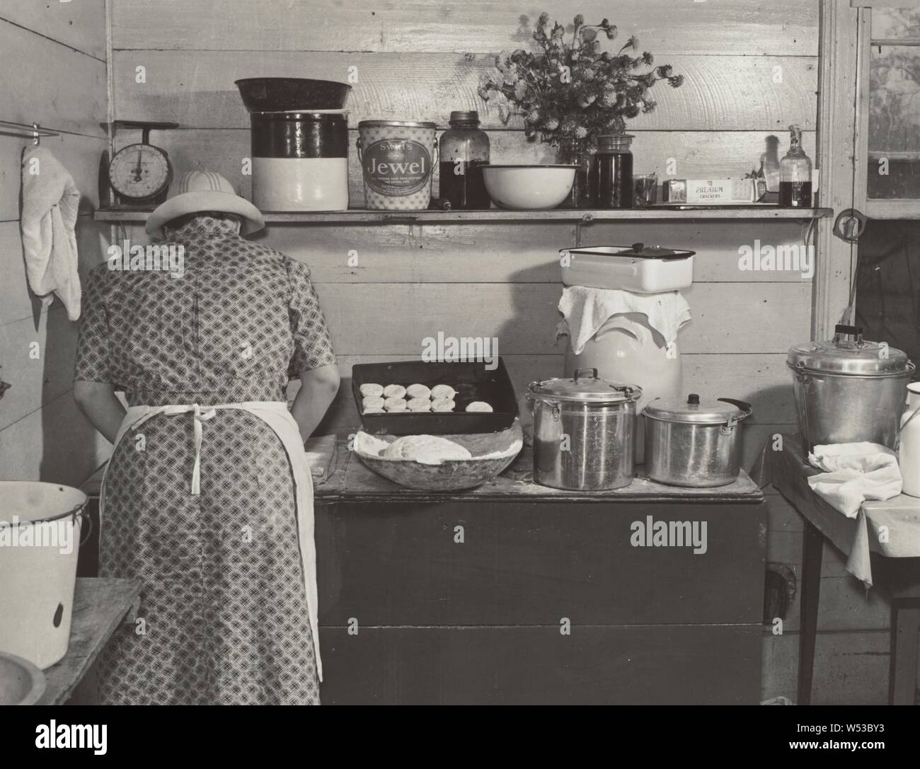 One of the Wilkins family making biscuits for dinner on cornshucking day at Mrs. Fred Wilkins' home near Tallyho, Granville County. North Carolina, Marion Post Wolcott (American, 1910 - 1990), North Carolina, Granville County, United States, September 1939, Gelatin silver print, 21.2 × 28 cm (8 3/8 × 11 in Stock Photo