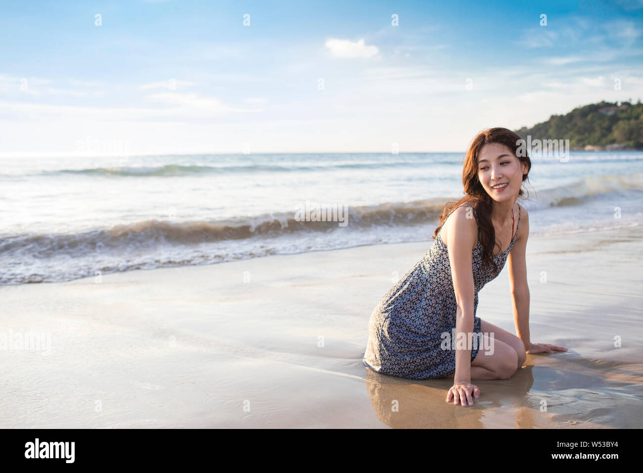 Happy young woman on beach Stock Photo - Alamy