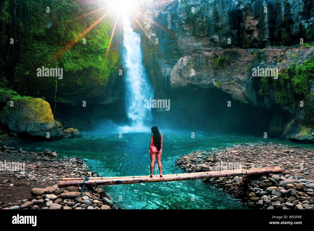 Beautiful woman enjoy amazing waterfall hidden in tropical jungle at ...