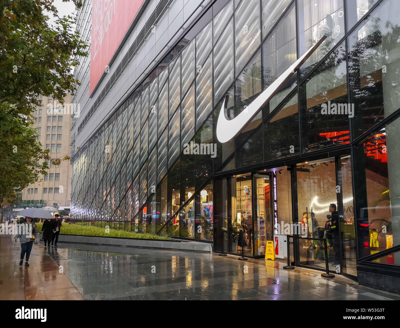 FILE--Pedestrians walk past a Nike sportswear store in Shanghai, China, 22 October  2018. Nike Inc has caught onto the sustainability trend in Chin Stock Photo  - Alamy