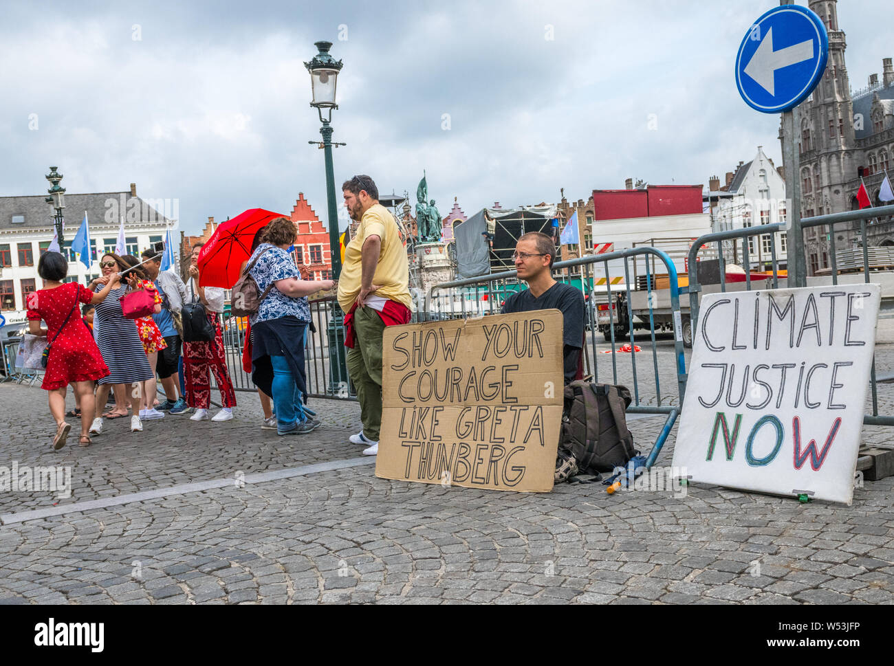 Wouter Mouton, a climate change activist with his carboard placards in the centre of Bruges, Belgium. Stock Photo