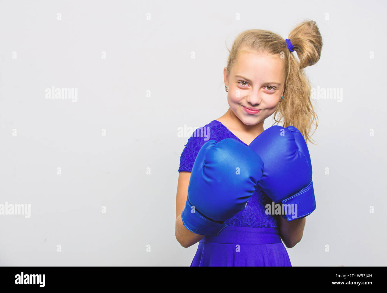 little girl in boxing gloves punching. knockout and energy. Sport