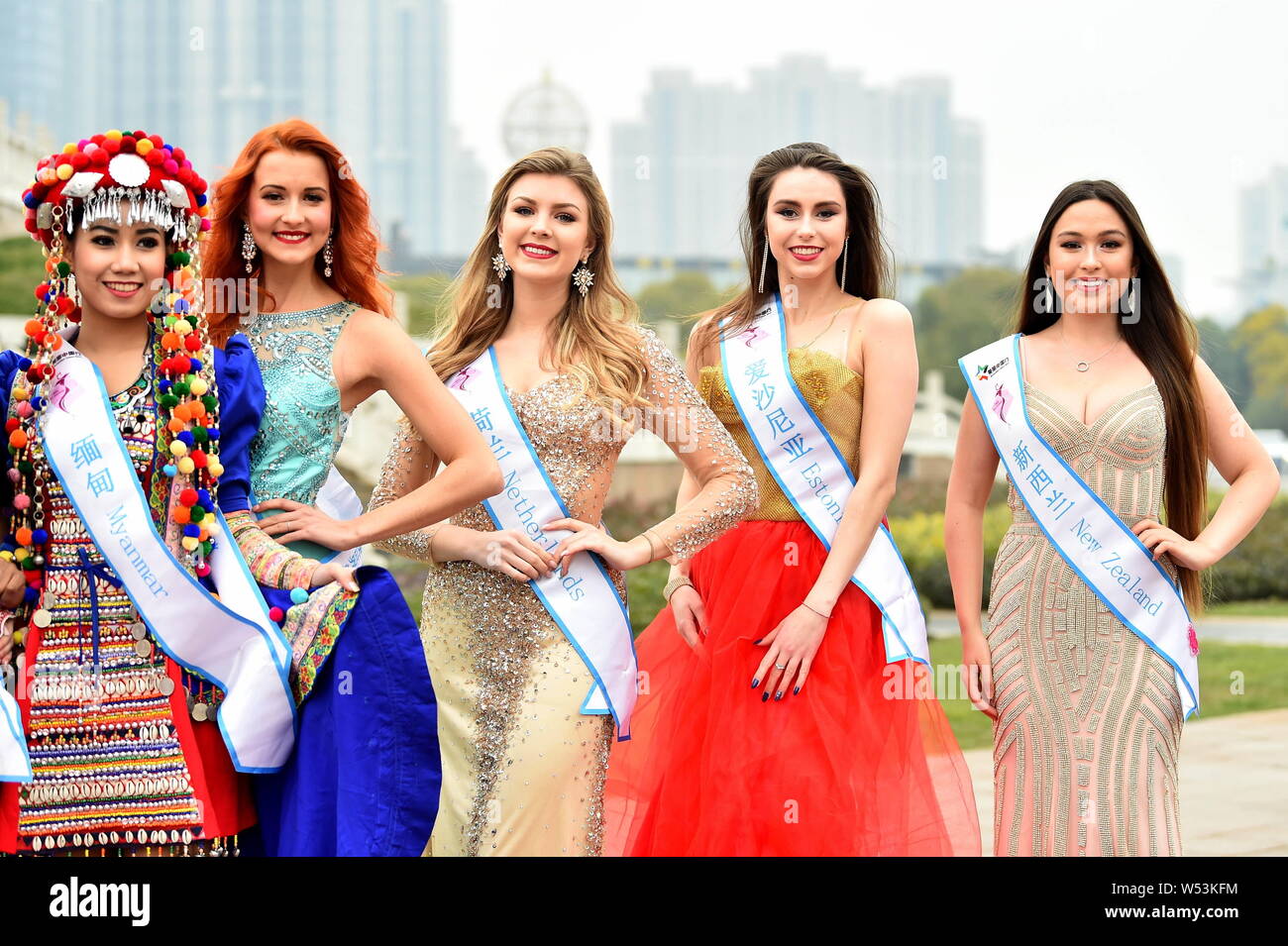 Contestants clad in traditional costumes or evening dresses take part in an outdoor photo session for the 53th Miss All Nationsl Pageant in Nanjing ci Stock Photo