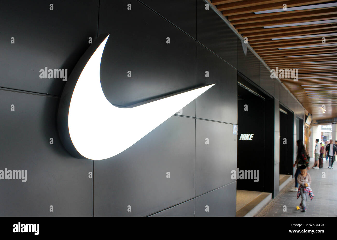 FILE--Pedestrians walk past a Nike sportswear store in Xiamen city,  southeast China's Fujian province, 21 April 2018. Nike Inc has caught onto  the Stock Photo - Alamy