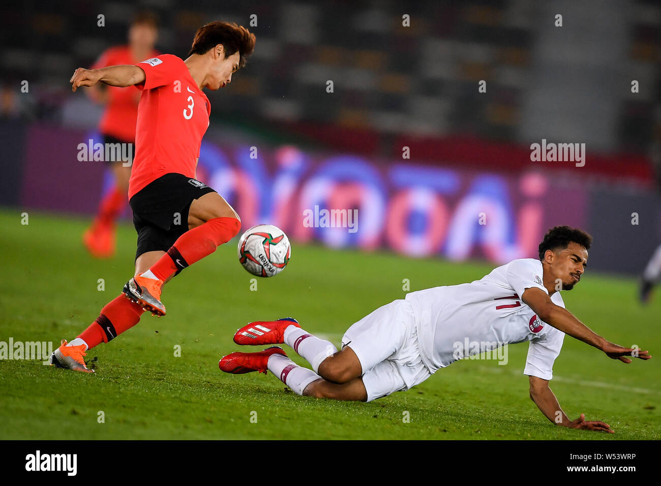 Kim Jin-su, left, of South Korea national football team passes the ball against a player of Qatar national football team in their quarter-final match Stock Photo