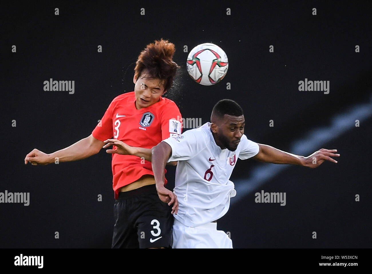 Kim Jin-su, left, of South Korea national football team heads the ball against Abdulaziz Hatim of Qatar national football team in their quarter-final Stock Photo