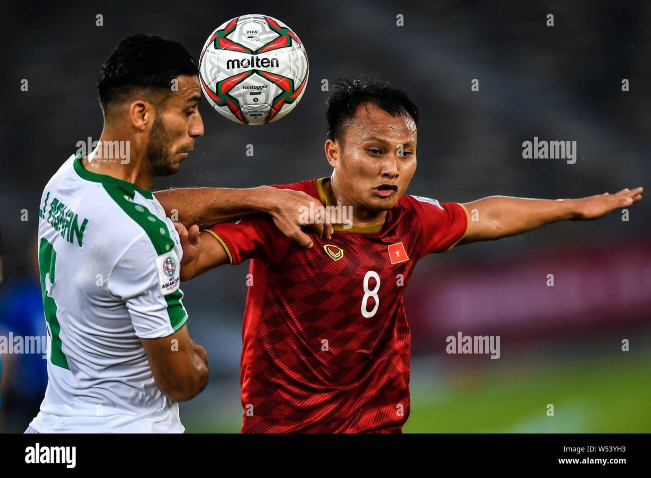 Ali Adnan, left, of Iraq national football team heads the ball against  Nguyen Trong Hoang of Vietnam national football team in the AFC Asian Cup  group Stock Photo - Alamy