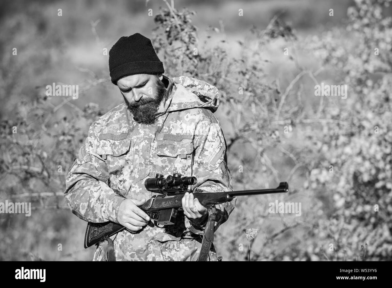 Bearded man hunter. Military uniform fashion. Army forces. Camouflage. Hunting skills and weapon equipment. How turn hunting into hobby. Man hunter with rifle gun. Boot camp. he is a business shark. Stock Photo