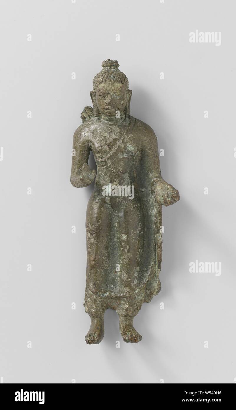 Standing Buddha, Statuette of standing Buddha, forearms raised to hip height, fingers of right hand broken off, dress closely fitting to the body, without folds. (Divine Bronze, no. 4), anonymous, Indonesia, 700 - 800, bronze (metal), h 12.4 cm × w 4.8 cm × d 2.9 cm × w 203 Stock Photo