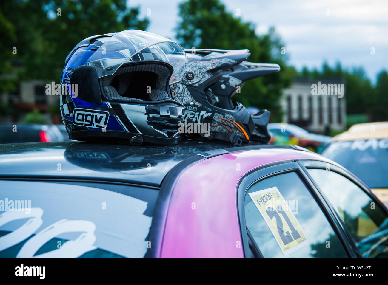 Race drivers left three helmets on car top Stock Photo