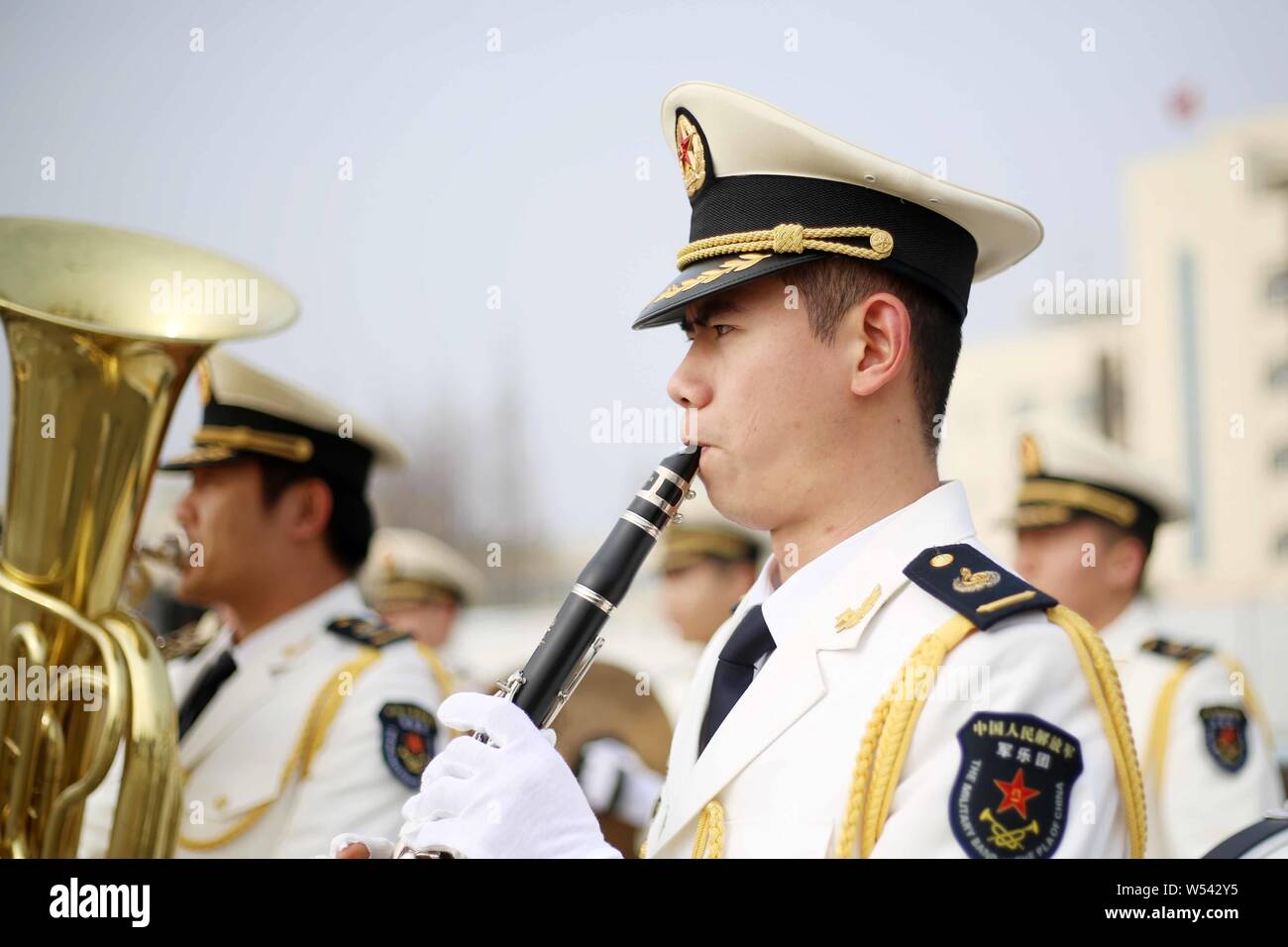 Band members of Chinese naval soldiers perform to welcome South Korean navy at a military port in Shanghai, China, 14 January 2019.   Two ships of the Stock Photo