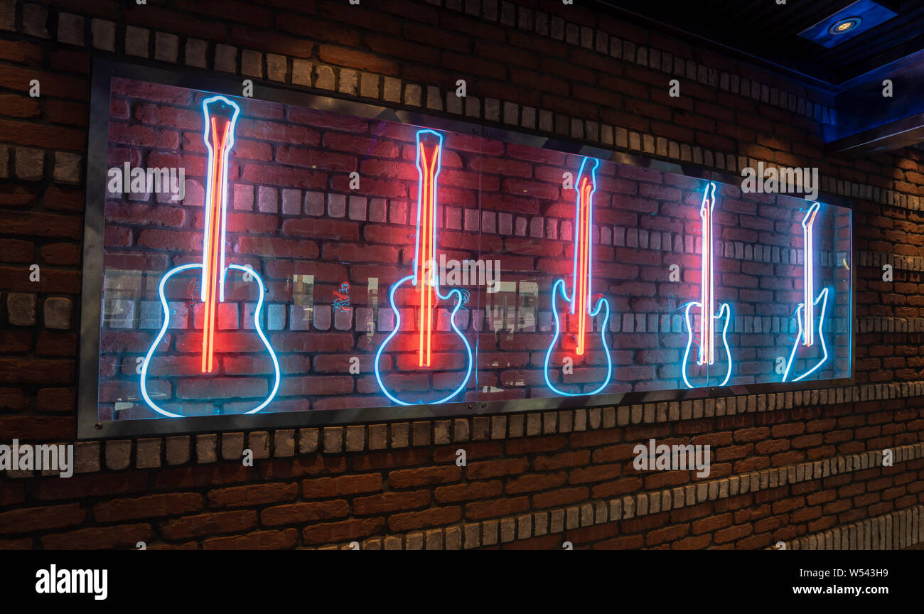 Rock Bar Neon decoration of Guitars on Brick Wall Stock Photo - Alamy