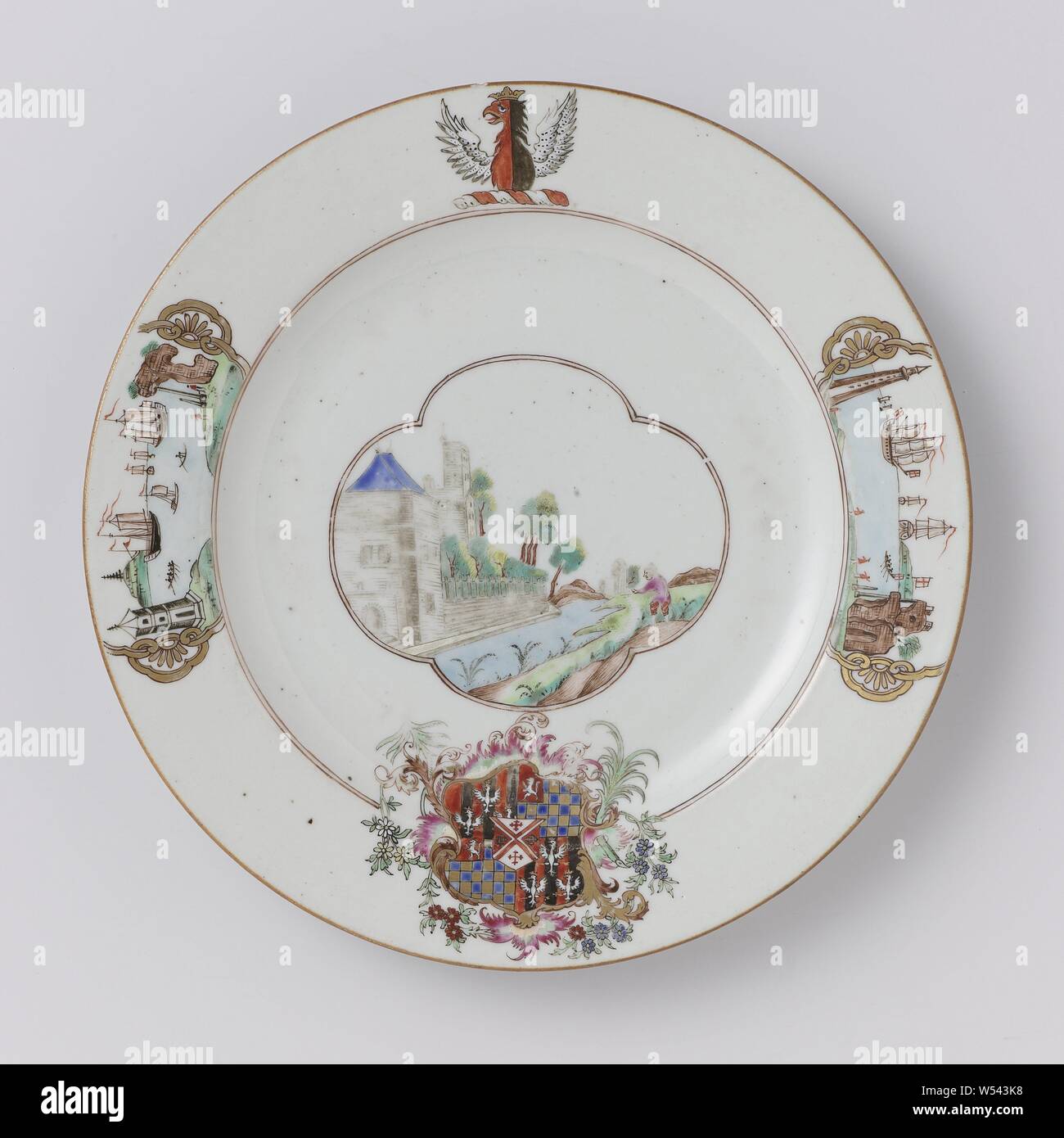 Plate with the arms of the Cooke, Twysden and Warren family, Porcelain plate, painted on the glaze in blue, red, pink, green, yellow, brown, black and gold. On the shelf a lobed cartouche with a European landscape with a fortress and a person on the waterfront, on the wall and border the coat of arms of the Warren and Cooke family with the coat of arms of the Twysden family in the heart. The weapon is divided into four planes: 1. and 4. three crowned birds on a red-black striped background, 2. and 3. a checkered ground in blue and gold with a lion in the left corner against a red background Stock Photo