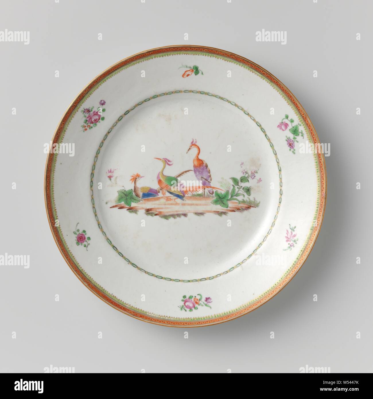 Plate with three cranes among plants, Porcelain plate painted on the glaze in blue, red, pink, green, yellow, purple, brown, black and gold. On the shelf three cranes among plants, the wall with a decorative band, the border with six separate flower sprays and a decorative band. Famille rose., anonymous, China, c. 1775 - c. 1799, Qing-dynasty (1644-1912) / Qianlong-period (1736-1795) / Jiaqing-period (1796-1820), porcelain (material), glaze, gold (metal), vitrification, h 3 cm d 23.4 cm d 12 cm Stock Photo