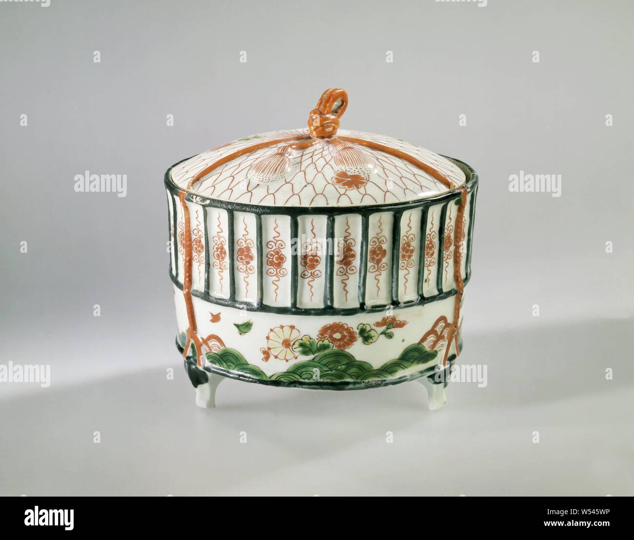 Cylidrical covered box in the shape of a cricket's cage, Cylindrical box of  porcelain on three legs and in the form of a cricket cage held together by  three modeled cords, ending