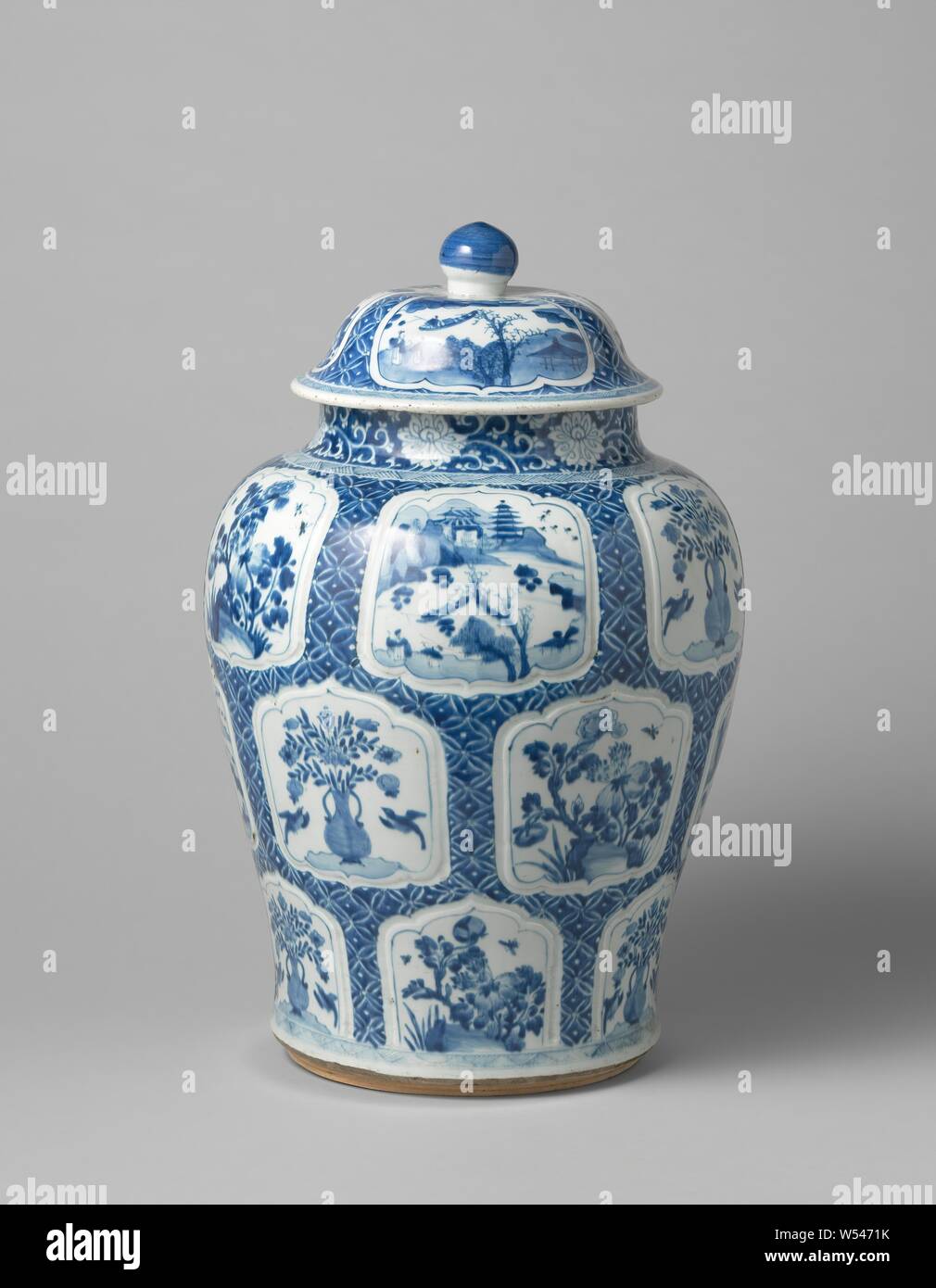 Baluster covered jar with flower vases, flowering plants and landscapes in panels, Baluster-shaped porcelain covered pot, painted in underglaze blue. The belly is covered with napkin work containing saved, modeled, scalloped cartouches with a flower vase (lotus) with two birds, flowering plants (peony) near a rock or a river cap with two people, a boat, pavilions, trees and mountains. The neck with stylized lotus tendrils. On the shoulder and around the foot a band with hatching. Blue and white., anonymous, China, c. 1680 - c. 1720, Kangxi-period (1662-1722), porcelain (material), glaze Stock Photo
