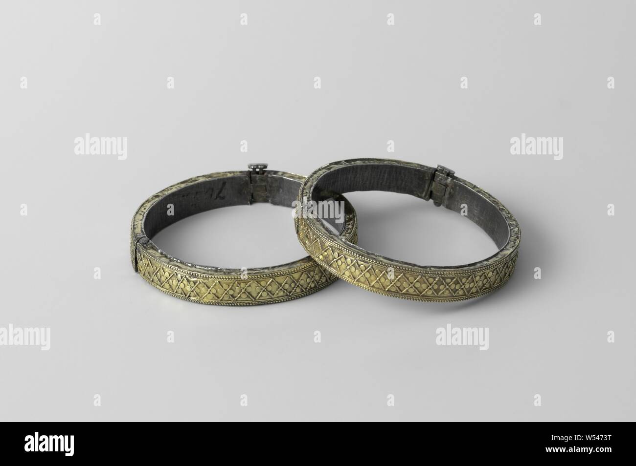 Pair of bracelets (chandan churi), Bracelet (chandan churi) with hinge and lock, silver plated with gold. Decorated with diamond motifs, small circles and four pearl borders., anonymous, Surat, c. 1750, gold (metal), silver (metal), striking (metalworking), d 6.5 cm × h 1.5 cm Stock Photo